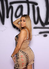 Woman posing against a wall with graffiti